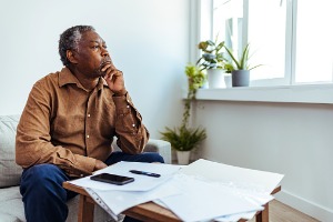 An older man filling out paperwork for Social Secuirty in Peoria IL