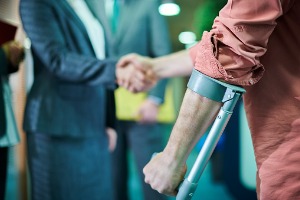 An injured man shaking hands with a civil litigation attorney in Peoria IL
