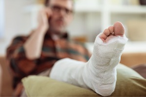 A man with a broken leg calls a Personal Injury Attorney in Dunlap IL, Rochford & Associates