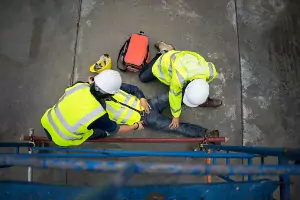 A man lays on the floor at work after getting hurt. If you need help, Rochford & Associates is an Accident Attorney in Peoria IL