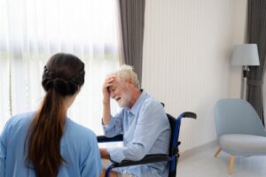 A man in a wheelchair sits with his head in his head. Rochford & Associates are Nursing Home Abuse Lawyers in Dunlap IL.